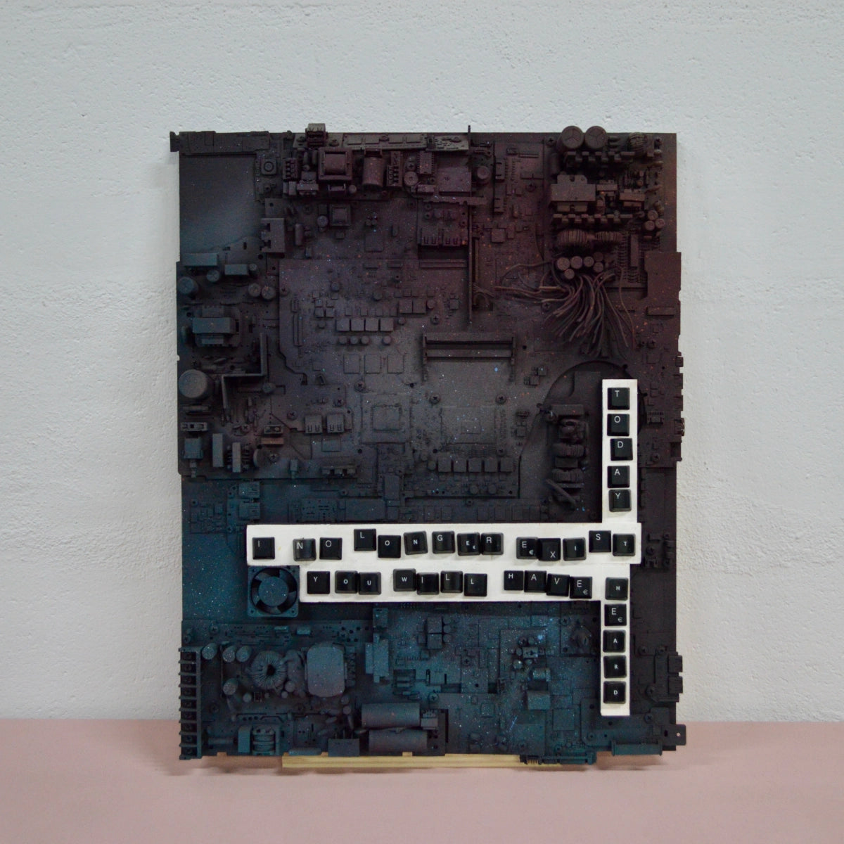 Mixed-media artwork made from electronic components and keyboard letters.